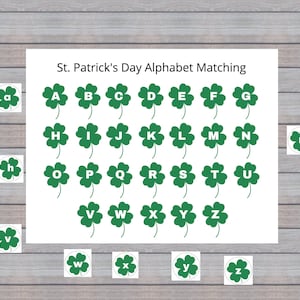 May include: A St. Patrick's Day alphabet matching game featuring the letters A through Z, each displayed on a green shamrock. Individual shamrocks with lowercase letters are scattered around the main board. The text "St. Patrick's Day Alphabet Matching" is at the top.