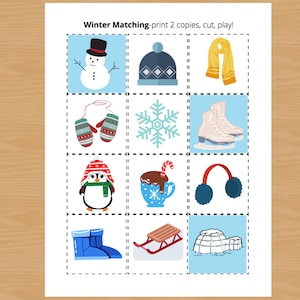May include: A printable winter-themed matching game with 12 colourful illustrations. The illustrations include a snowman, a hat, a scarf, mittens, a snowflake, ice skates, a penguin, a mug of hot chocolate, earmuffs, boots, a sled, and an igloo. The text "Winter Matching - print 2 copies, cut, play!" is at the top of the page.
