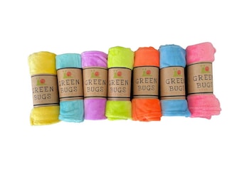 May include: A set of seven colorful, rolled-up fleece blankets with the words "Green Bugs" printed on each label.