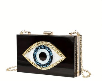 Evil Eye-clutch: zwarte acryl avondtasje met gouden kettingriem