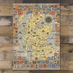 May include: A vintage map of Scotland, featuring a detailed illustration of the country's geography. The map is surrounded by colorful heraldic crests and the text "Map of Scotland". The puzzle is displayed on a wooden surface.