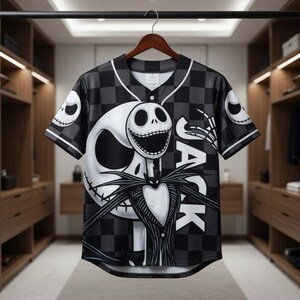 May include: Black and white baseball jersey featuring a large graphic of Jack Skellington from The Nightmare Before Christmas. The jersey has a checkered pattern and the word "JACK" on the front. The sleeves have skull designs.
