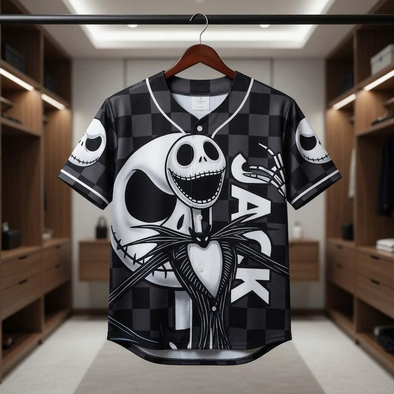 May include: Black and white baseball jersey featuring a large graphic of Jack Skellington from The Nightmare Before Christmas. The jersey has a checkered pattern and the word "JACK" on the front. The sleeves have skull designs.