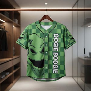 May include: Green baseball jersey featuring a checkered pattern and the face of Oogie Boogie from The Nightmare Before Christmas. The jersey has the text "OOGIE BOOGIE" down the side and is hanging on a wooden hanger.