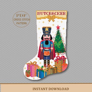 May include: A cross stitch pattern for a Christmas stocking featuring a Nutcracker holding a drum, a Christmas tree, and presents. The pattern is in PDF format and is available for instant download.