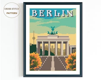 May include: Cross stitch pattern of the Brandenburg Gate in Berlin, Germany. The gate is a white stone structure with five arches and a statue on top. The pattern is set against a blue sky with clouds and a yellow sunset.
