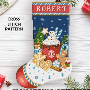 Op de afbeelding: Een kruissteekpatroon voor een kerstsok met de naam "ROBERT" bovenaan. De sok heeft een sneeuwpop, een peperkoekman, sneeuwvlokken en andere vakantie-thema ontwerpen. De tekst "CROSS STITCH PATTERN" is ook zichtbaar.