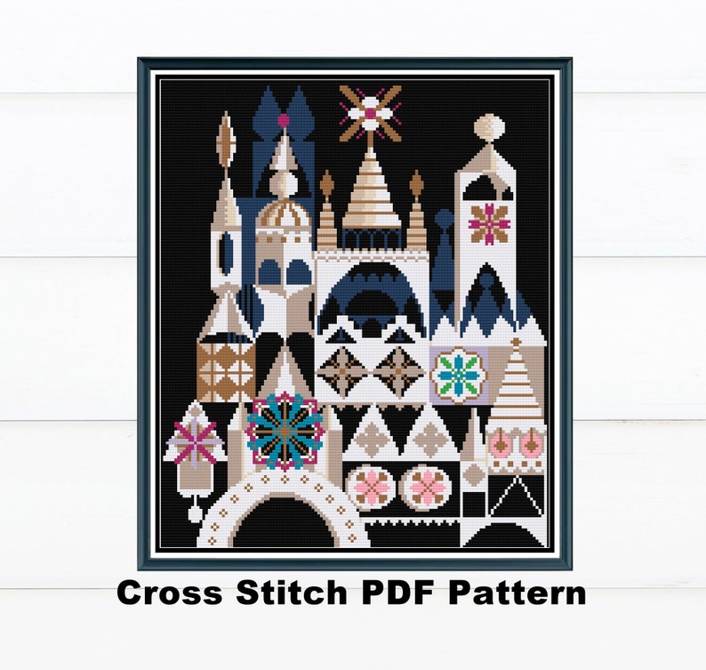 May include: A framed cross-stitch pattern featuring a colorful, stylized architectural design against a black background. The design includes geometric shapes in white, tan, blue, and gold. The text "Cross Stitch PDF Pattern" is at the bottom.