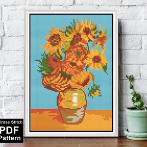 May include: Cross stitch pattern of a vase with sunflowers. The vase is brown and the sunflowers are yellow with green leaves. The background is blue.