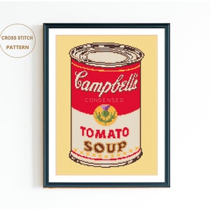 May include: Cross stitch pattern of a red and white Campbell's Soup can with the text "CONDENSED TOMATO SOUP" on the label.
