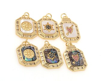 May include: Six gold-toned pendant charms with different designs. Each charm features a square frame with a white or iridescent shell background and a different design in the center. The designs include a snowflake, a heart with an arrow, and a star.