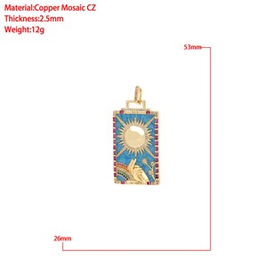 May include: Gold pendant necklace with a blue and white enamel sun design, surrounded by pink cubic zirconia stones. The pendant is 2.6 cm wide and 5.3 cm tall.