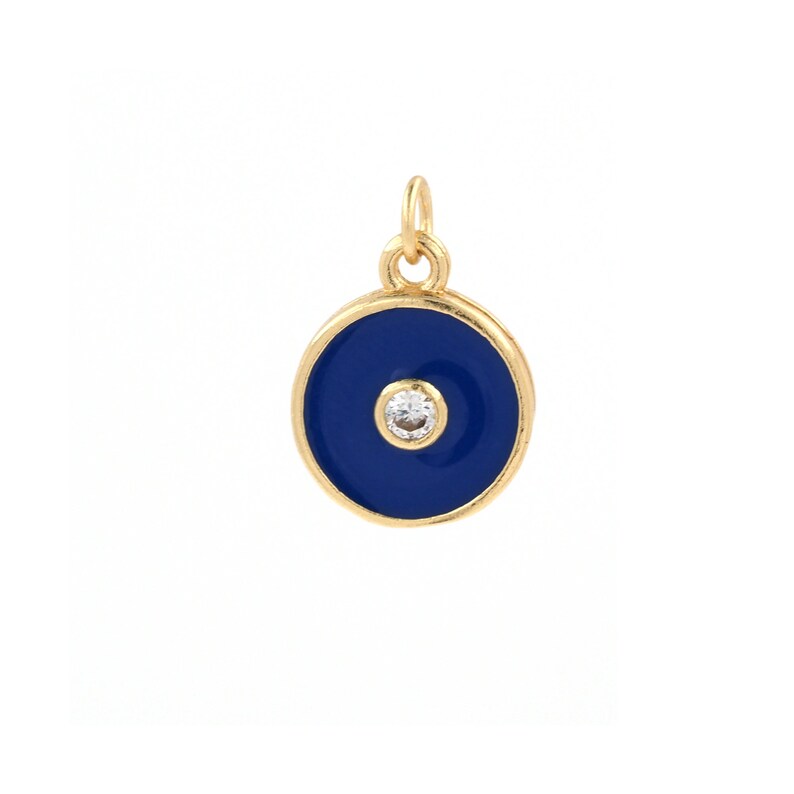 May include: Gold charm with a blue enamel circle and a small clear rhinestone in the center. The charm is designed to resemble a protective eye.