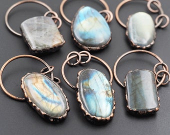May include: Six copper wire wrapped labradorite gemstone bottle stoppers. Each stopper features a different shape and size of labradorite stone.