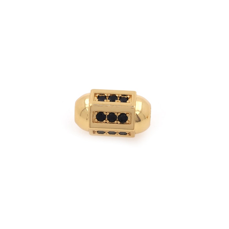 May include: Gold-toned bead with black cubic zirconia stones set in a rectangular frame.