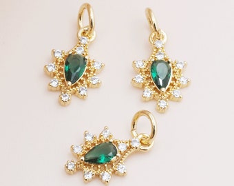 May include: Three gold-tone pendant charms with a green gemstone and clear crystal accents. Each charm features a teardrop-shaped green gemstone surrounded by a halo of clear crystals.