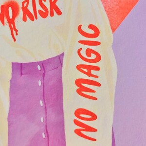 May include: A long-sleeve cream-colored shirt featuring the red text NO RISK on the chest and NO MAGIC printed vertically down the sleeve, paired with a purple button-front skirt. The shirt has a spray-painted red heart detail near the text.