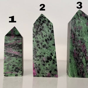 May include: Three green, black, and pink zultanite gemstone points, labelled 1, 2, and 3.