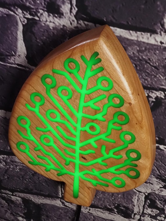 A real circuit board embedded in green epoxy resin with a cherry-leaf motif and actual LED backlighting — nature meets tech in a genuinely one-of-a-kind handcrafted piece.