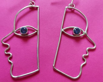 Superbes boucles d'oreilles en argent sterling serties d'yeux en zirconium bleu