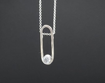 Unusual sterling silver and white cubic zirconia pendant. Matching earrings available
