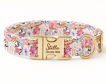 May include: A pet collar featuring a floral pattern in shades of pink, blue, and brown on a white background. It includes a gold-toned metal buckle engraved with the name Stella and the phone number 123-456-7890, plus a gold D-ring.