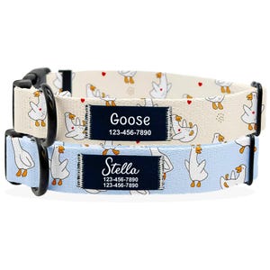 May include: Two dog collars with a whimsical goose pattern. One collar is light blue, the other is cream. Each collar has a black buckle and a navy blue patch with a name and phone number.
