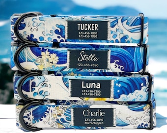 May include: Four dog collars stacked on top of each other. The collars are blue and white with a wave pattern and have black metal D-rings. Each collar has a black label with white text that includes a dog's name, phone number, and microchip information. The names on the collars are Tucker, Stella, Luna, and Charlie.
