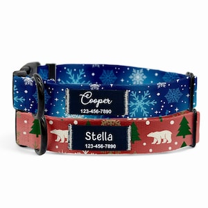 May include: Two personalized dog collars. One is blue with white snowflakes and the name "Cooper" on a black label. The other is red with white polar bears, green trees, and the name "Stella" on a black label.