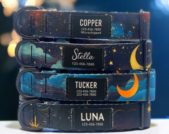 May include: Four dog collars stacked on top of each other. The collars are made of a dark blue fabric with a white and yellow moon and stars pattern. Each collar has a black tag with white text. The tags read "Copper 123-456-7890 Microchipped", "Stella 123-456-7890", "Tucker 123-456-7890 123-456-7890", and "Luna 123-456-7890".