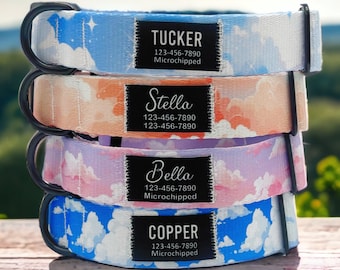 May include: Four dog collars stacked on top of each other. The collars are made of a soft fabric with a cloud pattern and have black buckles. Each collar has a black tag with a dog's name, phone number, and the words "Microchipped". The names on the tags are Tucker, Stella, Bella, and Copper.