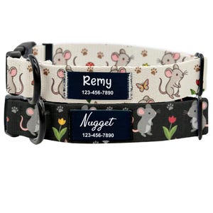 May include: Two personalised dog collars. One is cream-coloured with a mouse and paw print pattern, the other is black with a mouse and floral pattern. Each collar has a navy blue name tag with a name and phone number.