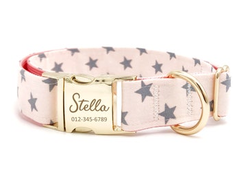 May include: Pink dog collar with a gold buckle and a gray star pattern. The buckle has the name "Stella" and the phone number "012-345-6789" engraved on it.