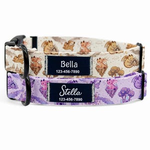 May include: Two dog collars with dragon and castle patterns. One collar is beige with brown dragons, the other is purple with pink dragons. Each collar has a black name tag with a name and phone number.