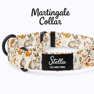 May include: A cream-coloured Martingale collar featuring a repeating pattern of rabbits and autumnal leaves. The collar has a black metal D-ring and a black name tag with the name "Stella" and a phone number.