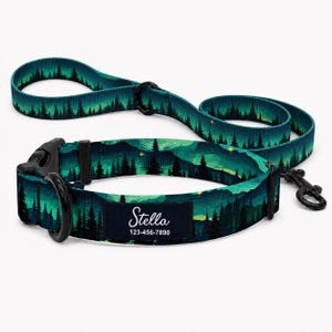 May include: A teal and dark green dog collar and matching leash set featuring a forest and night sky pattern. The collar includes a black plastic buckle, a metal D-ring, and a rectangular black tag with the white text Stella 123-456-7890.