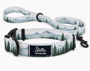 Può includere: Un set composto da collare e guinzaglio per animali con stampa di un paesaggio montano e foresta di pini nei toni dell'azzurro e del verde. Il collare presenta una fibbia in plastica nera, un anello a D in metallo nero e l'etichetta Stella 123-456-7890.
