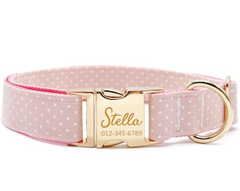May include: Pink dog collar with white polka dots and a gold buckle. The buckle has the name "Stella" and phone number "012-345-6789" engraved on it.