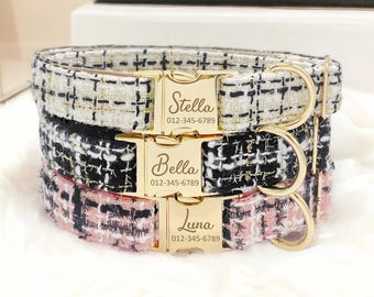 May include: Three dog collars with gold buckles and engraved names and phone numbers. The collars are layered on top of each other. The top collar is white with gold thread, the middle collar is black with white thread, and the bottom collar is pink with white thread. The names on the collars are Stella, Bella, and Luna.