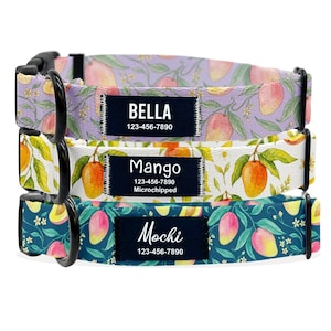 May include: Three dog collars with colorful mango patterns. Each collar has a black buckle and a name tag with a pet's name and phone number. The collars are in shades of purple, white, and teal.