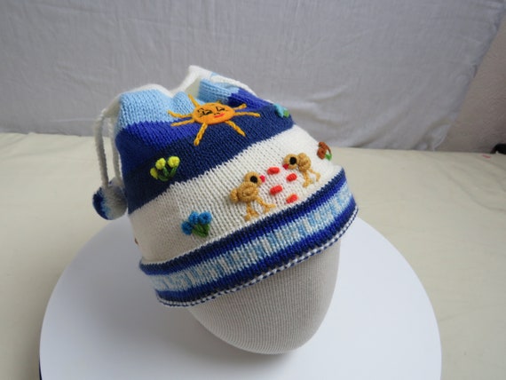 Childrens Peruvian arpillera bobble hats.Knitted beanie with applique/embroidery. Made in Peru. Fair Trade. Size fits 6 mths to 3yrs