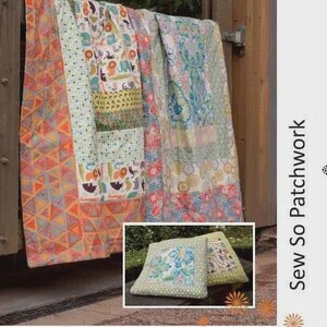 May include: A colorful patchwork quilt draped over a wooden structure, featuring geometric and floral patterns in shades of orange, blue, and green. The text "QUILT IN A PILLOW" is at the top. A smaller image shows two pillows with similar designs.