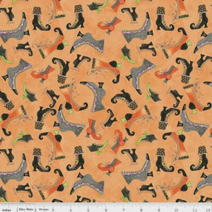 May include: Orange fabric featuring a repeating pattern of stylised witch boots in black, grey, orange, and green. The boots have various designs, including laces and buckles. The background has a textured appearance.