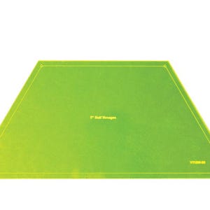 May include: A green 5-inch half hexagon plastic template for quilting or sewing projects. The template has the text "5" Half Hexagon" printed on it.
