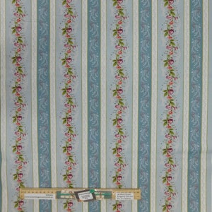 May include: Blue and white striped fabric with a floral pattern. The fabric has a delicate lace design and features pink and green flowers. The fabric is ideal for quilting, sewing, and crafting.