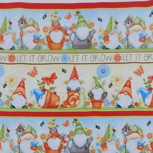 May include: A patterned fabric panel with illustrations of garden gnomes in various poses, wearing hats and surrounded by flowers and insects. The text "LET IT GROW" is printed across the panel. The colour scheme includes red, green, and blue.