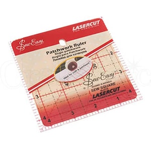 May include: A red and white plastic patchwork ruler with a grid pattern and measurements in inches. The ruler is packaged in a clear plastic bag with the brand name "Sew Easy" and the text "Lasercut for Precision" printed on it.