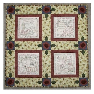 May include: A patchwork quilt with a floral background and four embroidered panels. Each panel displays a garden-themed design with text. The quilt's border features appliqued flowers and leaves.
