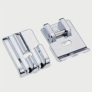 May include: Two shiny, chrome-plated sewing machine presser feet. One foot has a series of parallel grooves, while the other has a rectangular shape with a hole and a hinged bar. These feet are designed for sewing applications.
