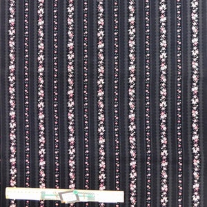 May include: Black fabric with vertical stripes of pink and white floral print. The fabric has a subtle texture.
